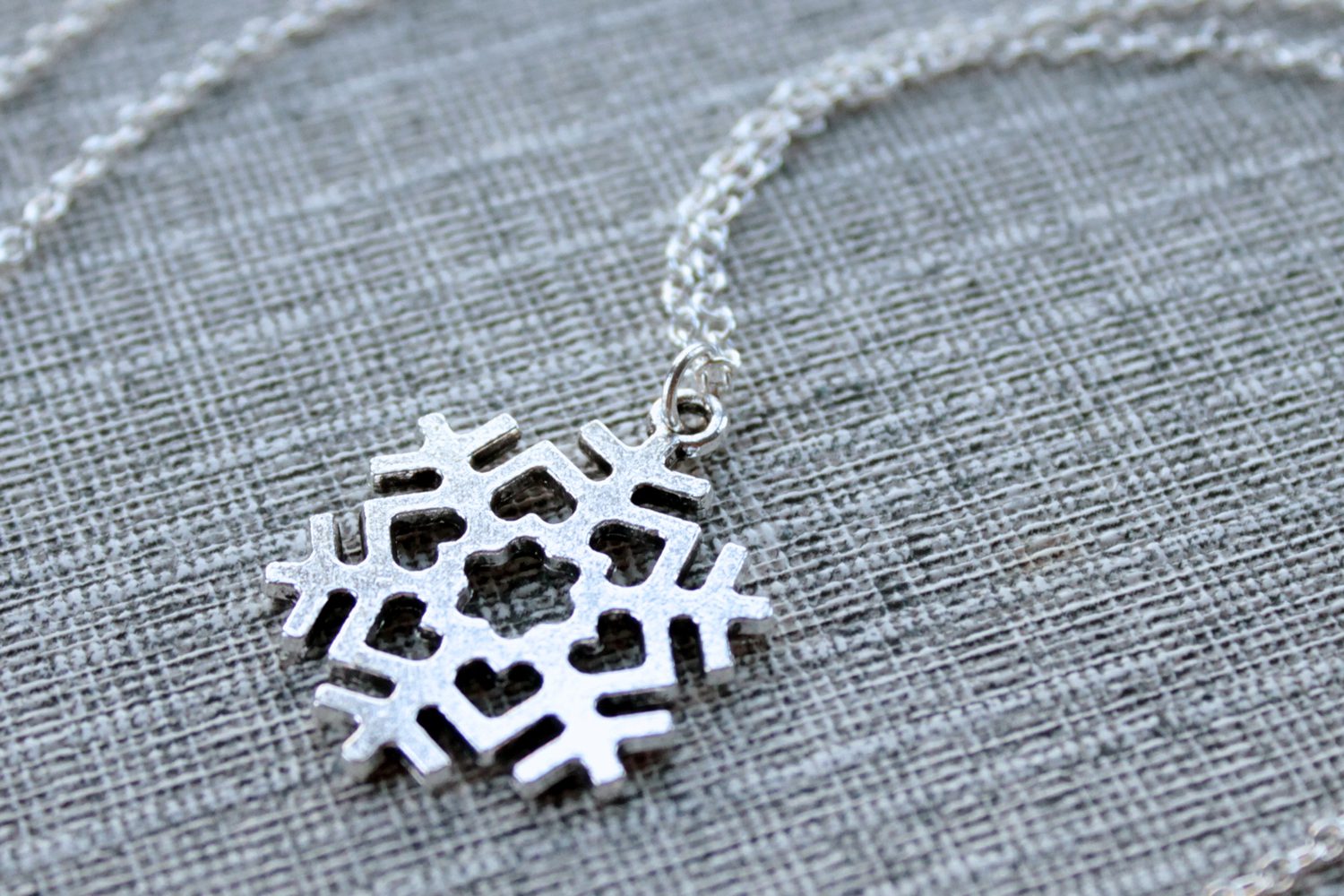 Silver snowflake love necklace, minimalist jewelry design by Liz @PurlsAndPixels