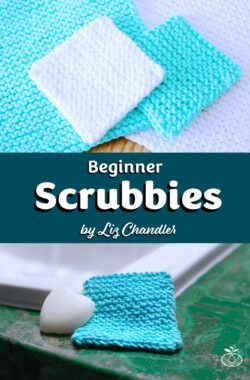 Finished knitted beginner face scrubbies in white and teal.