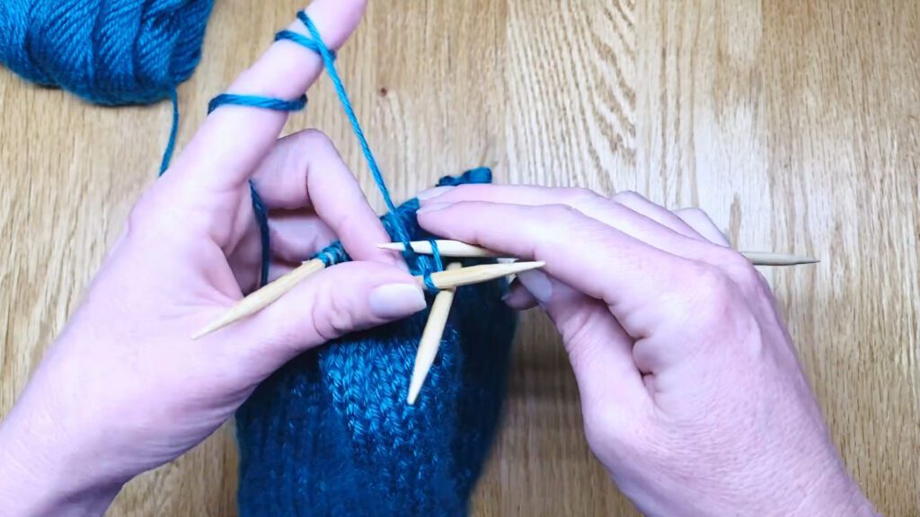 Step 10: Learn to switch from circular needles to double point needles (DPNs) by closing a bottom-up hat top in this knitting lesson with Liz Chandler @PurlsAndPixels.