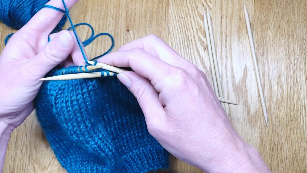 Step 3: Learn to switch from circular needles to double point needles (DPNs) by closing a bottom-up hat top in this knitting lesson with Liz Chandler @PurlsAndPixels.