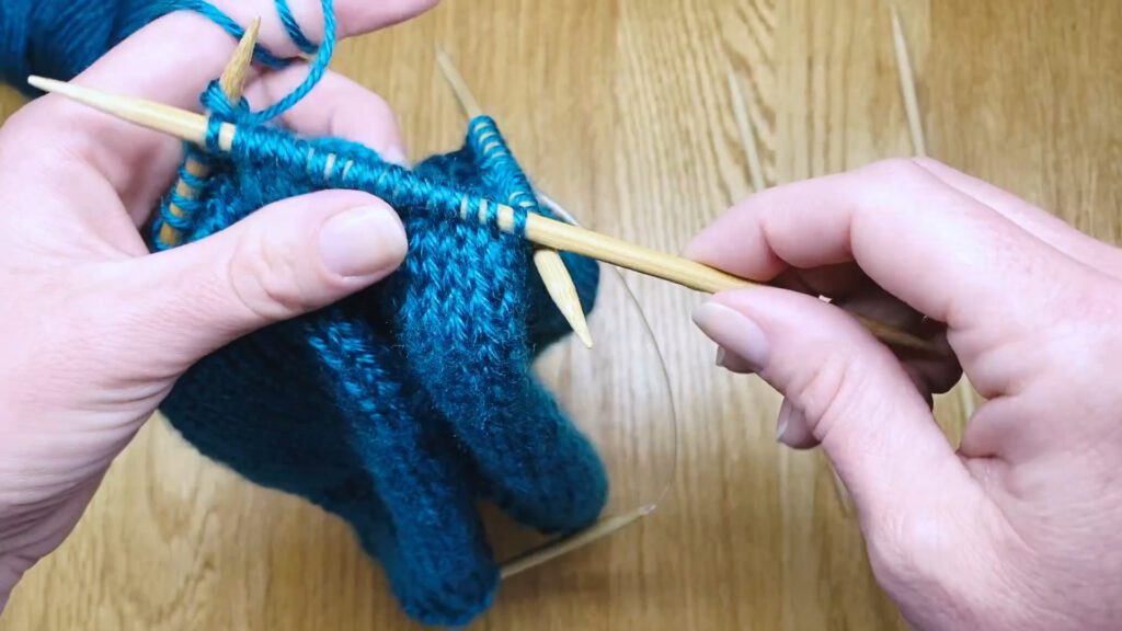 Step 6: Learn to switch from circular needles to double point needles (DPNs) by closing a bottom-up hat top in this knitting lesson with Liz Chandler @PurlsAndPixels.