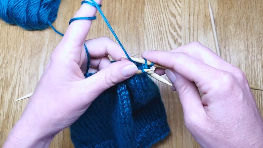 Step 7: Learn to switch from circular needles to double point needles (DPNs) by closing a bottom-up hat top in this knitting lesson with Liz Chandler @PurlsAndPixels.