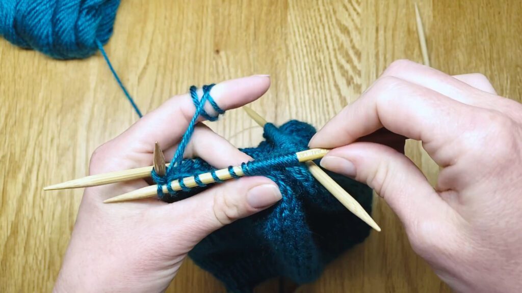 Step 8: Learn to switch from circular needles to double point needles (DPNs) by closing a bottom-up hat top in this knitting lesson with Liz Chandler @PurlsAndPixels.