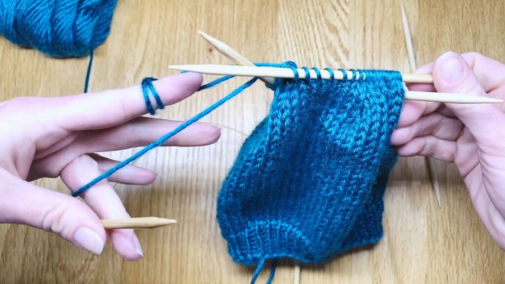 Step 9: Learn to switch from circular needles to double point needles (DPNs) by closing a bottom-up hat top in this knitting lesson with Liz Chandler @PurlsAndPixels.