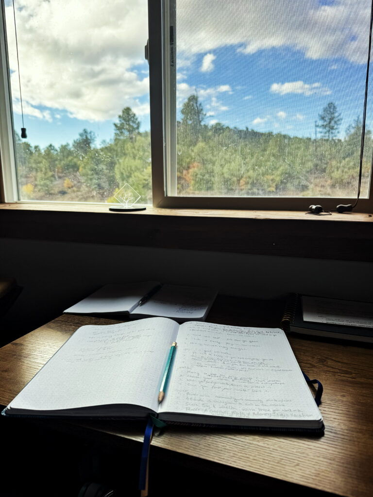 A small notebook near the window view of the forest with flowing natural light can inspire all your knitting projects.