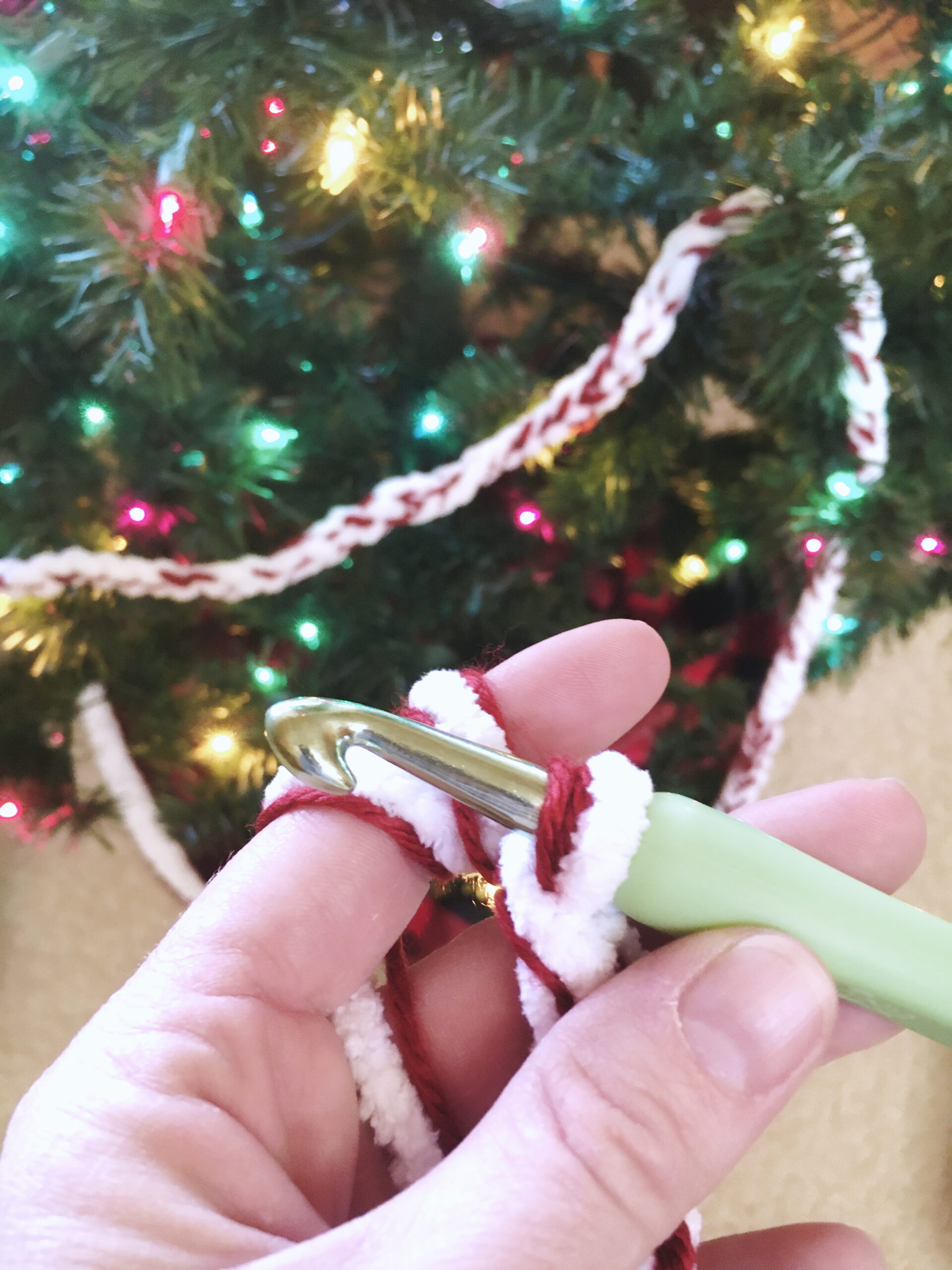 Crochet a peppermint twist garland from red and white yarn. you can crochet it straight onto the Christmas tree for a festive home decoration. Happy Holidays!