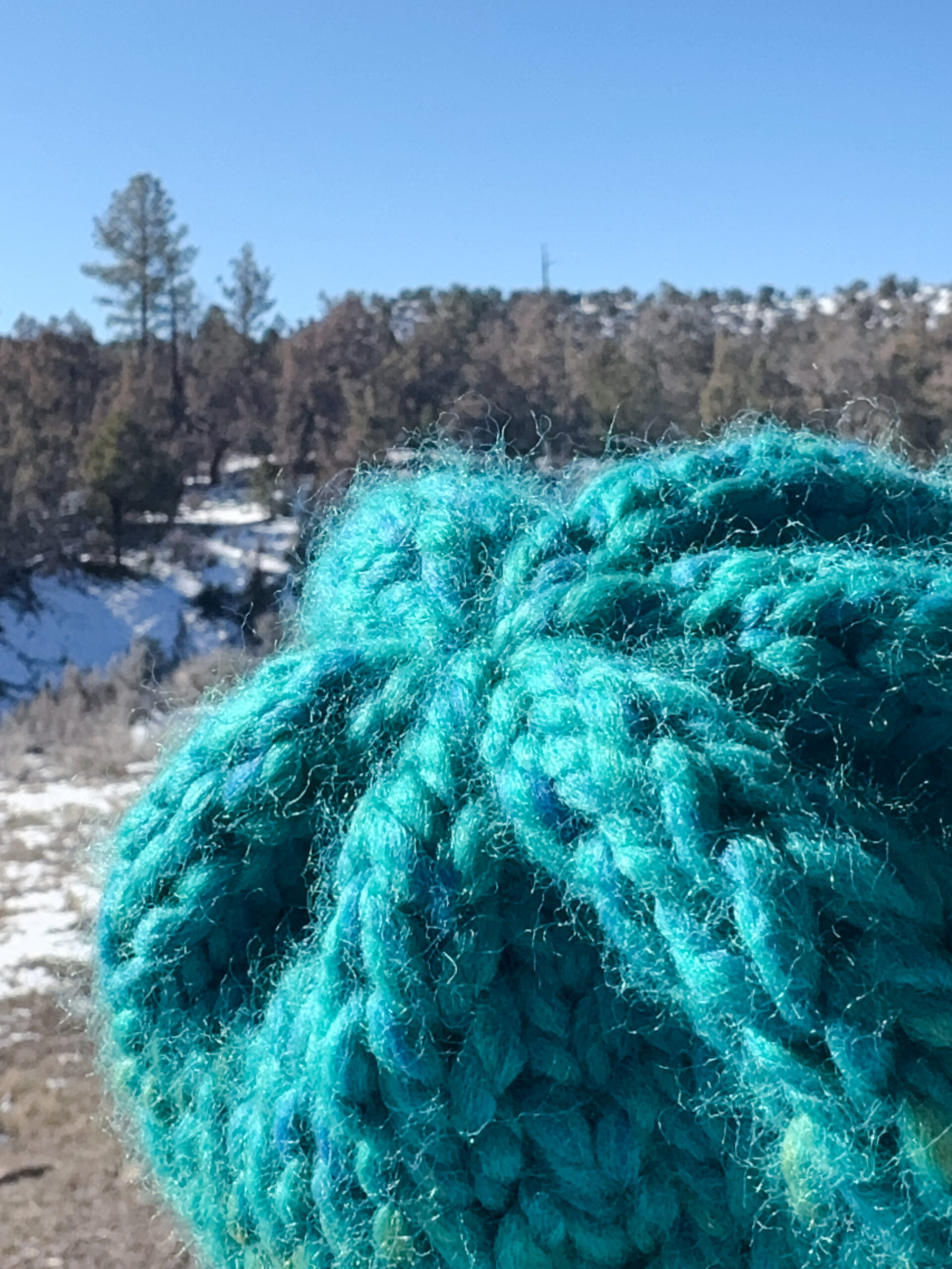 Lesson 9, Kids' Knitting Guide – drawing yarn through remaining stitches to close the top of a knitted hat.