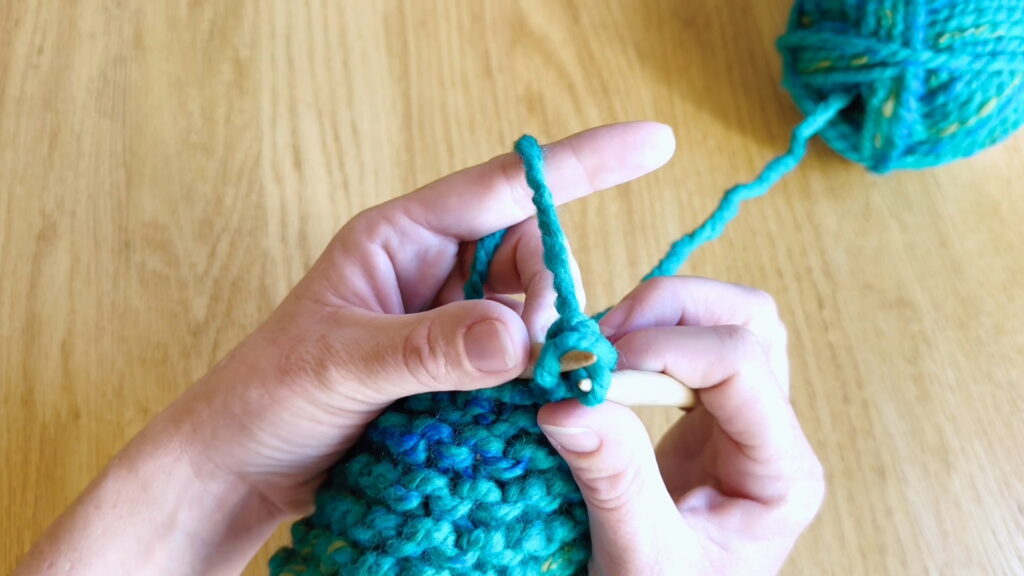 Second stitch pulled through the first stitch while binding off knitted stitches.