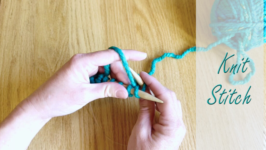 Hands preparing to teach the knit stitch in the next kids' knitting lesson.
