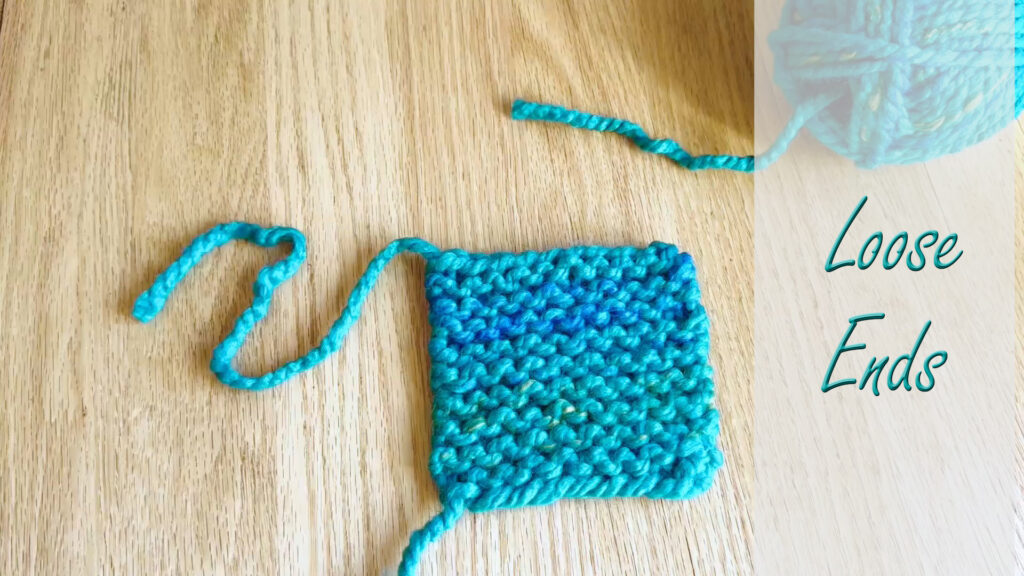 Finished beginner knit piece showing loose yarn ends ready to be woven in.