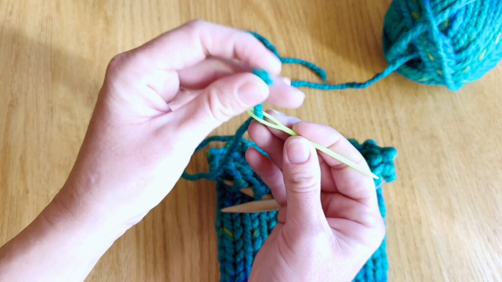 Lesson 9, Kids' Knitting Guide – threading yarn onto a darning needle.