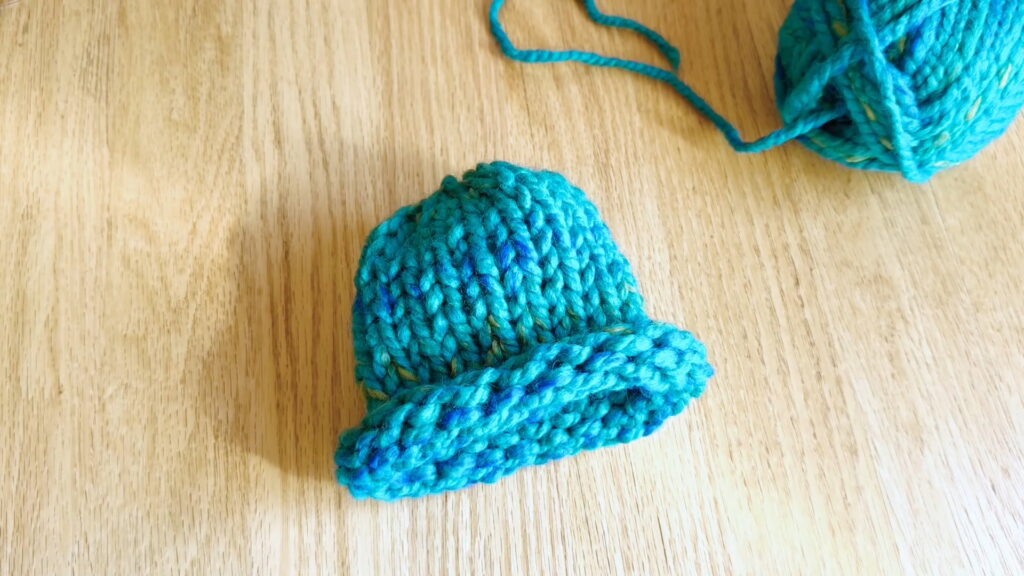 Lesson 10, Kids' Knitting Guide – finished knitted hat ready to wear after weaving in loose ends.