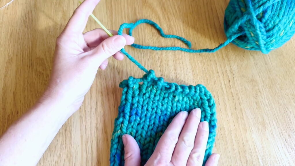 Lesson 9, Kids' Knitting Guide – pulling the yarn tail through stitches to remove them from the knitting needle.