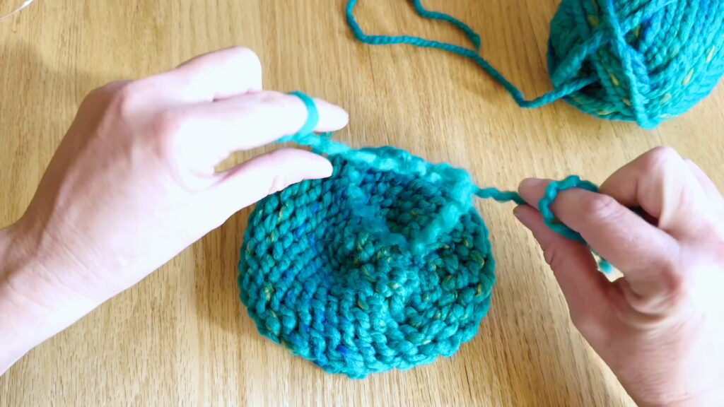 Lesson 10, Kids' Knitting Guide – tying a second knot to secure the yarn tail in place.